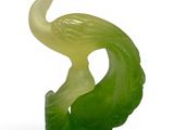 green jade sculpture of a bird on a leaf with a white background