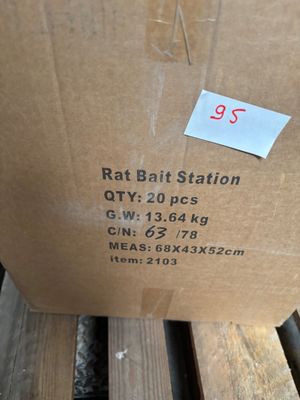 a box of rat bait sitting on top of a wooden bench