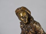 bronze figurine of a girl with a basket of apples