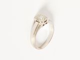 a close up of a diamond ring on a white surface