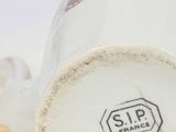a close up of a white cup with a stop sign on it