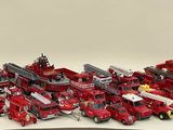 a lot of toy firetrucks that are on the table