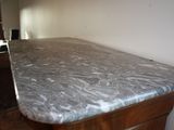 a marble counter top on a wooden cabinet in a room
