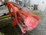 a red machine that is sitting in the dirt