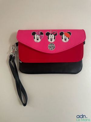 a pink and black purse with mickey mouses on it