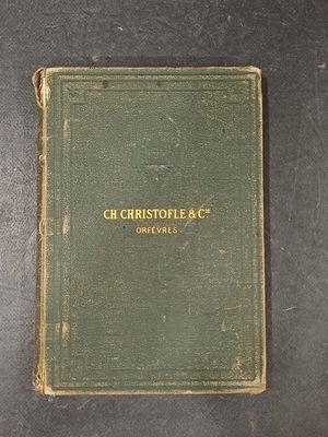 an old book sitting on top of a table next to a cup of coffee