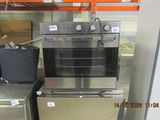 a stainless steel oven sitting on top of a metal counter