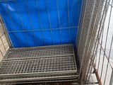 a blue tarp on the back of a metal cart