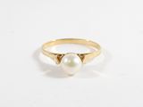 a gold ring with a pearl on top of it
