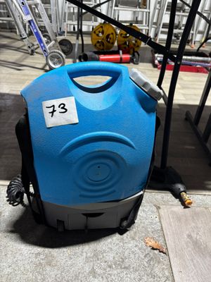 a blue and black vacuum cleaner sitting on the ground