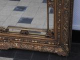 a mirror that is sitting on the floor in a room