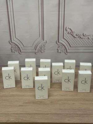 several small boxes of perfume sitting on top of a wooden table