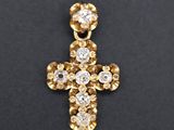 a diamond cross pendant on a black background