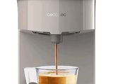 an image of a white coffee machine with a cup of coffee