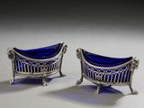 pair of silver and blue glass chairs on a white surface