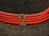 a black hat with a red cord around it and a number 2 on it