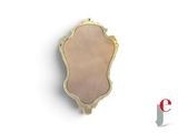 a small mirror hanging on the wall next to a letter e