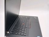 a black laptop with a red button on the keyboard