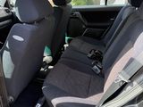 the interior of a car with the door open showing the front seats