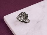 a diamond ring sitting on top of a white marble slab