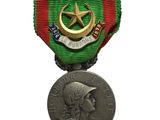 medal with a star on the front of it and a medal on the back of the medal
