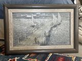 a picture of a painting on the floor next to a bed