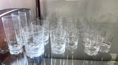 a lot of glasses that are sitting on a glass table