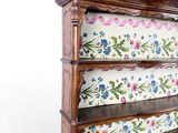 a wooden shelf with a floral design on it