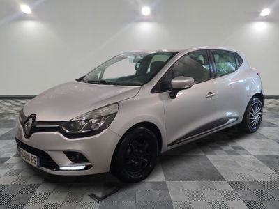 a white car parked on a checkered floor in a garage