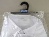 a white shirt in a plastic bag on a hanger