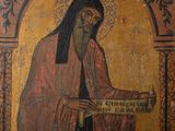 an old painting of a man holding a scroll in his right hand