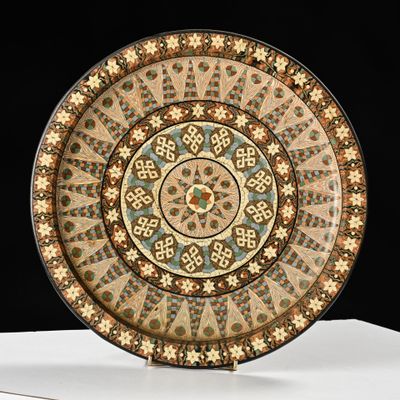 an image of a decorative plate sitting on top of a white table