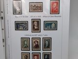 an open book with a bunch of stamps on it sitting on a table