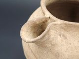 a close up of a clay vase on a table