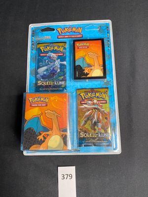 four pokemon cards in a plastic case on a table