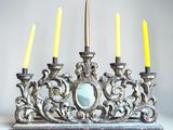 a silver and gold menorat with four candles on it