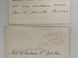 two old envelopes with handwritten letters are displayed on a white surface