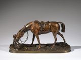 bronze statue of a horse with a saddle on its head