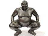 an image of a statue of a sumo sitting on his knees