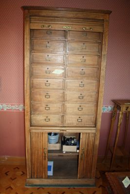 a tall wooden cabinet in the corner of a room