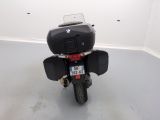 a motorcycle parked in a room with a white wall