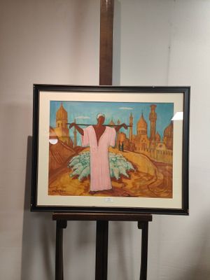 une photo d'un tableau posé sur un chevalet, avec une croix en arrière-plan