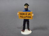 a figurine of a man holding a sign that says non a la pollution