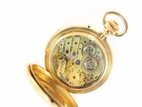 a gold pocket watch with a chain hanging from it ' s side