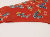 a red shirt with blue and yellow flowers on it