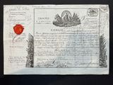an old document with a red wax stamp on it sitting on a table