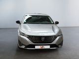 the front view of a silver car in a white room