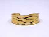 a close up of a gold ring on a white surface