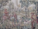 a tapestry with a picture of a man on a horse in the woods