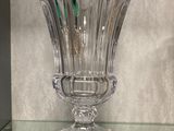 a glass vase sitting on top of a glass shelf